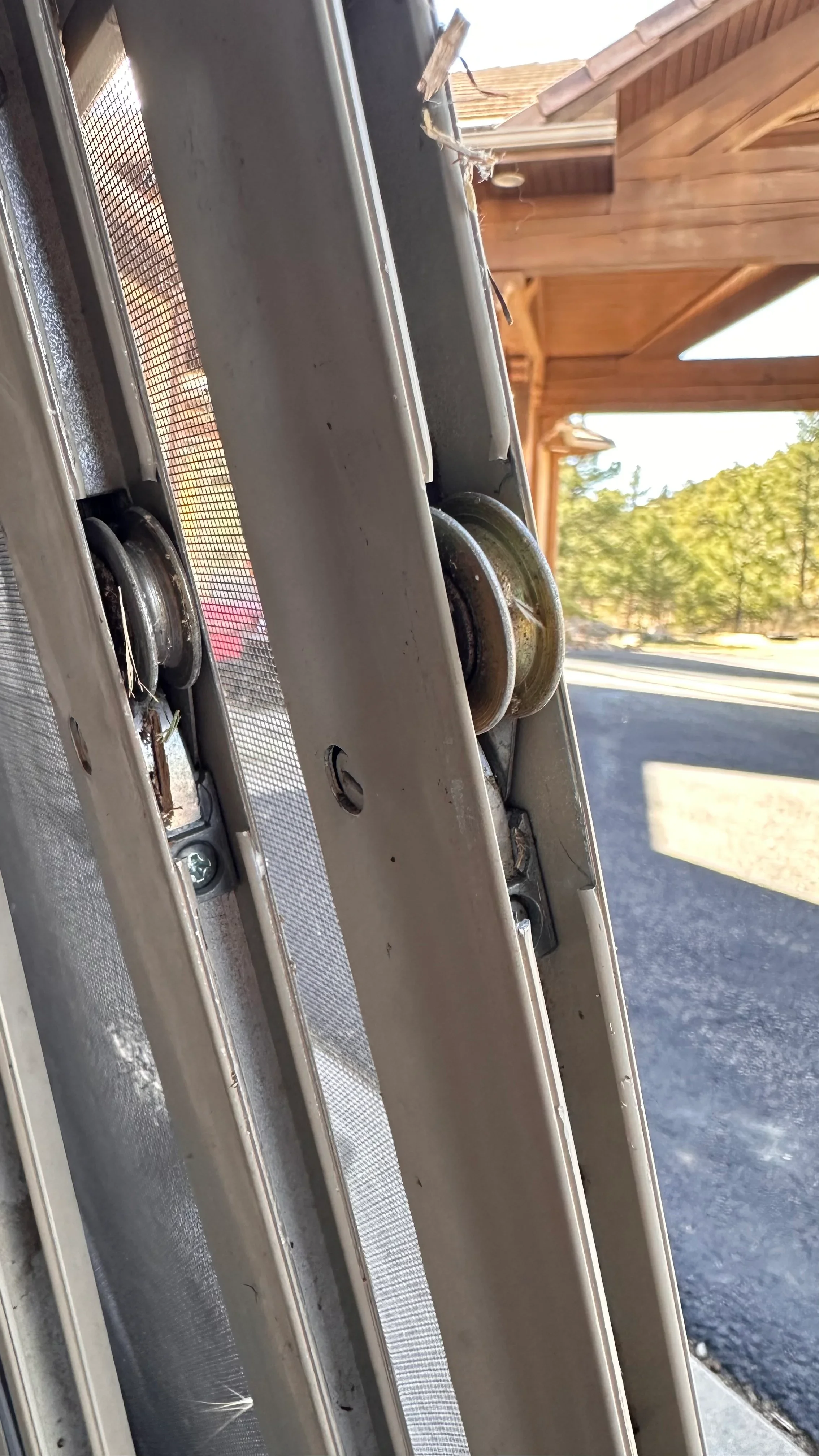 Screen door rollers and frame hardware repair on residential patio door